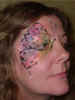 Face Painting: Adult female with pearlescent butterfly wing painted about her right eye.